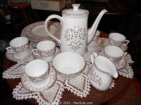 All pieces arranged on table with lace doily