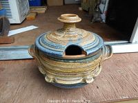 Front view of the handcrafted ceramic tureen with lid showing side handles and thumb notch in lid