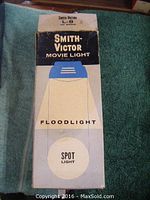 Photo of original box showing Smith Victor L-8 Movie Light label and flood and spot light options.