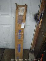 Original cardboard box packaging showing Da-Lite branding, contains the projection screen.