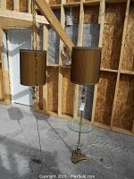 Photo of the vintage matching floor lamp and hanging lamp set showing the floor lamp with glass table and the hanging lamp on a chain with cord.