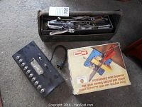 Photo showing old metal toolbox filled with assorted tools, Jointmaster sawing jig box, and vintage metal switch box with toggle switches.