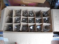 Top down view of all wine glasses packed in cardboard box with dividers, showing multiple glasses from above.