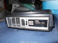 Close-up photo of the front of the Kodak Carousel 650H projector showing the model label and control switches for flame and fan.