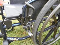 Close-up of the wheelchair frame showing brand name MyOn and part of the seat area