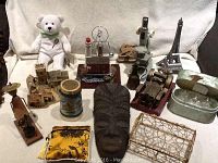 Full lot showing teddy bear, miniature village, crystal angels, microscope, and clay mask