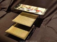 Photo showing three tiered plate display with cheese-themed top plate and two gold glittery plates on lower tiers