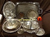 Full view of all silverplate trays and servingware pieces with measuring tape showing size of main trays