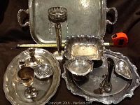 Photo showing large Reed & Barton Salem silverplate tray, candlestick holders with hanging droplets, and various silver serving dishes arranged together.