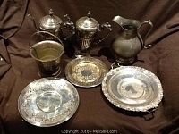 Overview photo showing two coffee pots, water jug, ice bucket, and trays arranged against dark cloth background.