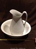 White ceramic wash basin with matching water jug, 15" wide basin and 12.5" jug visible.