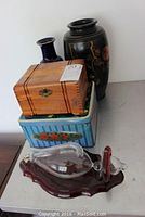 Two larger vases, cedar wood box, floral tin box, and glass barometer on wooden base shown from front and side angles.