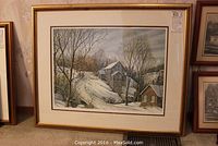 Full framed and matted print of a winter rural landscape titled 'Mill Lane' by Peter Robson, displayed standing against a wall with other framed artwork.