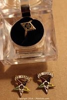 Photo showing gold Masonic lodge ring in a clear presentation box with black velvet interior; ring face has the Masonic symbol.