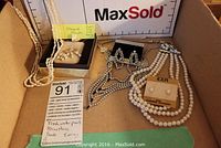 Full lot with freshwater pearl necklaces, rhinestone necklace, pearl earrings and boxed earrings