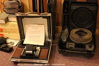 Close-up of Kodak Carousel 5600 projector lens and carousel slide tray in projector case