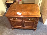 Front view of wooden Century night stand with drawer and cabinet doors.