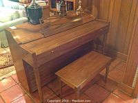 Full view of Baldwin upright piano and bench in room setting