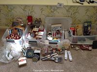 Wide view of bins containing various items including wooden nativity puzzles, small boxes, utensils and gifts.