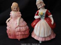 Front view of both Royal Doulton figurines, Valerie in pink dress and Rose in red and white dress.