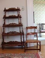Full view of the Victorian 5-tier whatnot and child-sized cane seat library chair side by side on wooden floor.