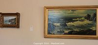 View of two landscape paintings hanging on wall, showing relative size difference and framing.