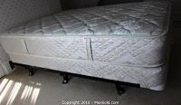 Mattress, box spring and bed frame assembled in room