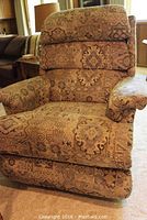 Front view of La-Z-Boy recliner showing the padded seat, armrests, and geometric patterned upholstery.