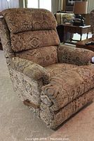 Front view of recliner showing patterned upholstery and padded armrests.