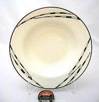 Top-down view showing the off-white bowl interior with black linear porcupine quill motif along rim.
