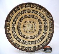 Top view of the woven basket showing the geometric black and natural pattern in concentric circles with a dark braided rim.