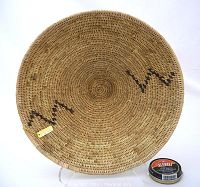 Top view of large circular woven basket showing tight weave and subtle dark markings