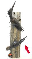 Two metal woodpecker sculptures mounted on a wooden plank, showing both birds from side angle with visible texture and detail.
