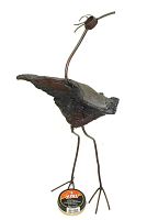Side view of the driftwood and metal bird sculpture with visible steel legs and curved neck.