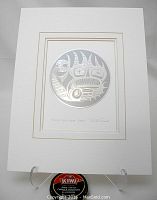 Full view of the embossed print matted and displayed on a stand