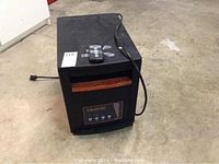 Front view of EdenPURE Gen3 electric heater with remote on top, showing overall condition and size.