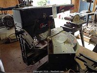 View of the left side of the radial arm miter saw showing the circular blade and arm extension.
