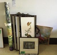 Original architectural etching framed with two framed floral design art pieces and a rolled abstract print visible