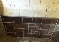Single large rectangular leaded glass panel leaning against wall; geometric central grid pattern