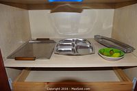 Shelf with several serving platters and side bowl on display