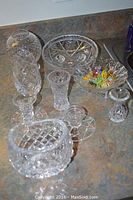 View of all crystal items showing vase, candlesticks, bud vase, candy dish, footed bowl and ashtray