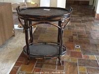 Oval bamboo and wicker style serving table, showing overall structure and removable top tray.