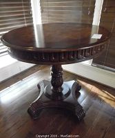 Full view of the round mahogany pedestal occasional table showing the base and top