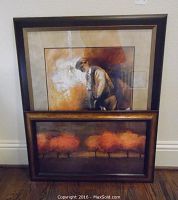 Two framed wall art prints leaning against a wall, showing size comparison and framing details