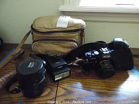Full view of Ricoh XR-2 camera, flash unit, and two lenses with beige camera bag in background