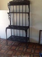 Full front view of the three-tier wrought iron bakers rack