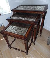 Three mahogany nesting tables stacked with leaded glass tabletops visible, showing overall design and size progression