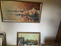 Wide view showing Harry Winkler oil painting of ships in harbor on wall with two framed prints leaning below
