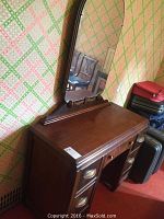 Full view of vintage wooden desk with attached large mirror, showing wood finish and overall design.