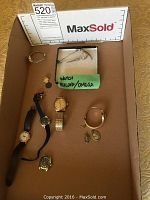 Overall box display showing all watches, bands, medals and pins